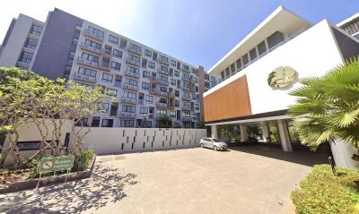 Modern residential building with spacious entrance and parking area