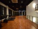 Spacious indoor gym with modern equipment and wooden flooring