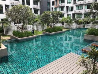 Spacious outdoor swimming pool surrounded by residential buildings