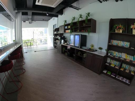 Spacious living room with modern shelving units, hardwood floors and natural light