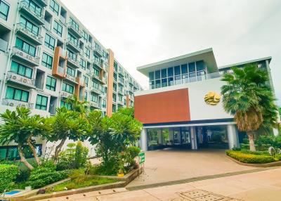 Modern residential apartment building entrance with lush greenery