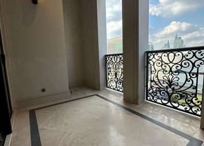 Spacious balcony with wrought iron railing and marble flooring overlooking the city