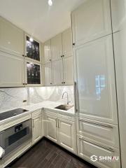 Modern kitchen with marble countertops and white cabinetry