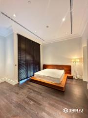 Modern bedroom with large bed and hardwood flooring