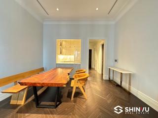 Spacious dining room with wooden furniture and modern lighting