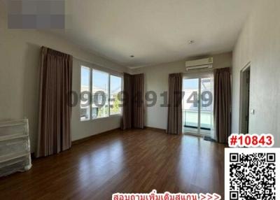 Spacious bedroom with large windows and hardwood floors