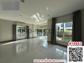 Spacious living room with large windows and reflective tile flooring