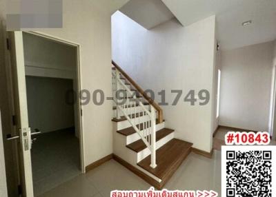 Bright staircase area with wooden stairs in a modern home