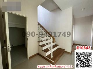 Bright staircase area with wooden stairs in a modern home