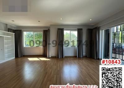 Spacious empty living room with hardwood floors and sunlight