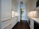 Modern kitchen with white cabinetry and marble countertops