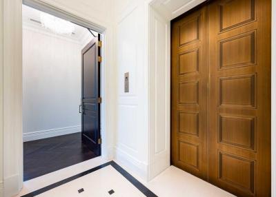 Elegant entrance hall with wooden door and white walls
