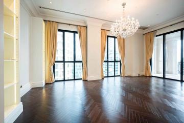 Spacious living room with large windows and chandelier