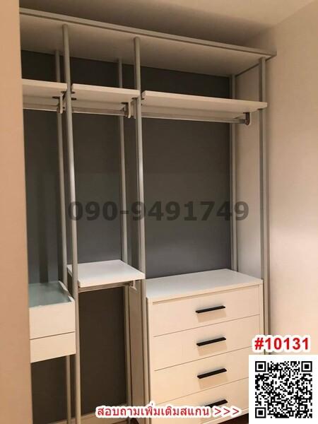 Open built-in closet in a bedroom with storage shelves and drawers