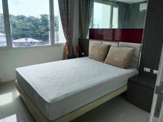 Modern bedroom with a large window and ample natural light