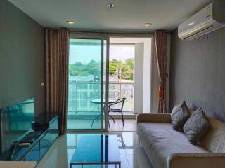 Bright living room with large window and balcony access