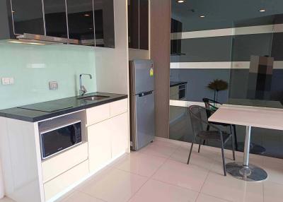 Modern kitchen with integrated appliances and breakfast table