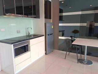 Modern kitchen with integrated appliances and breakfast table