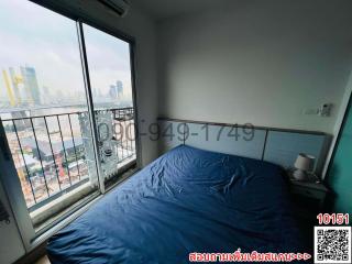 Cozy Bedroom with Large Window and City View