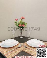 Elegantly set table for two in a modern dining area with flowers centerpiece