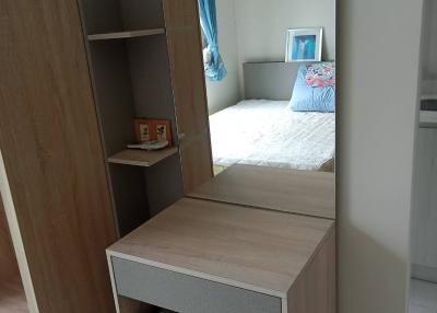 Modern bedroom with a study desk and a glimpse of the bed