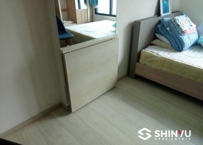 Compact bedroom with built-in wooden wardrobe and large mirror