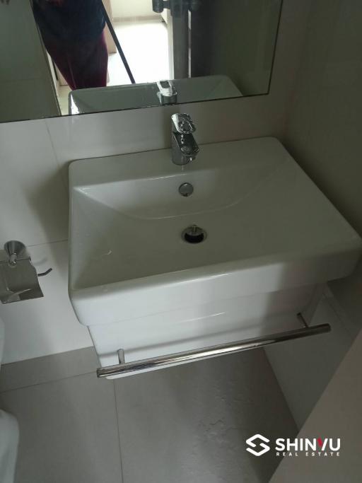 Modern white ceramic sink and faucet in a bathroom