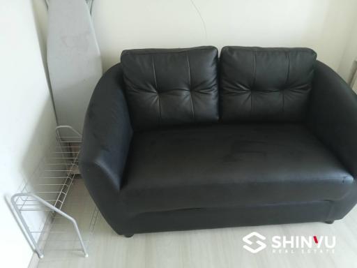 Black leather sofa in a modern living room setting