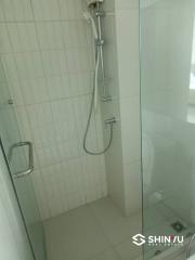 Modern bathroom with walk-in shower and white tiles