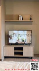 Cozy living room interior with mounted television and shelving