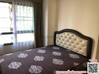 Well-lit bedroom with large bed and window curtains