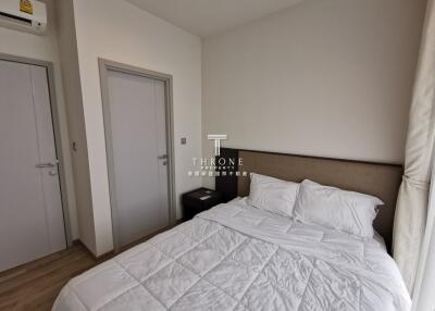 A modern bedroom with a bed and side table