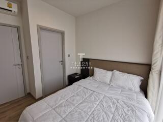 A modern bedroom with a bed and side table