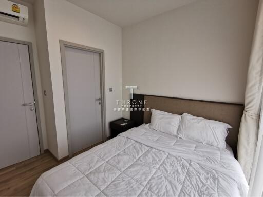 A modern bedroom with a bed and side table