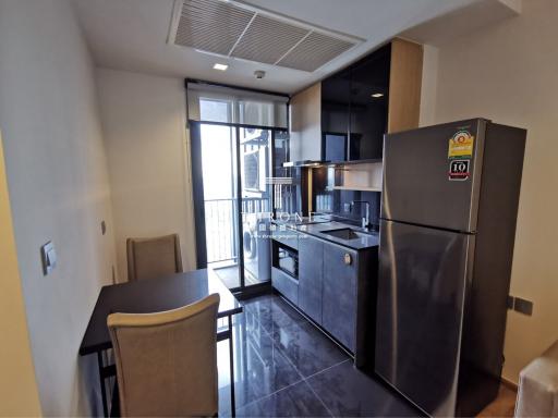 Modern kitchen with stainless steel appliances and dining area