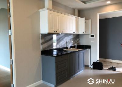 Modern kitchen with white cabinets and black countertop