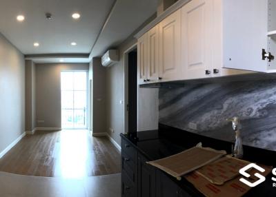 Modern kitchen with marble countertops and hardwood floors