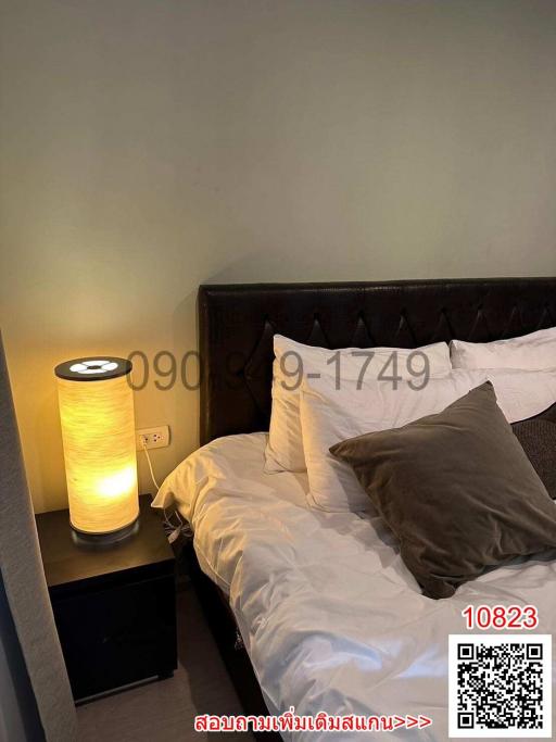 Cozy bedroom with bedside lamp and dark headboard