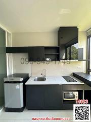 Modern kitchen with black cabinetry and stainless steel appliances