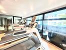 Home gym with treadmills and large windows overlooking the surroundings