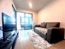 Modern living room with large windows and balcony access