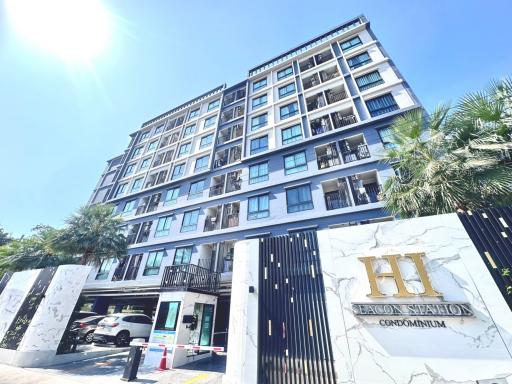 Exterior view of a modern condominium building with clear blue sky