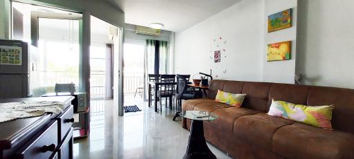 Spacious and well-lit living room with modern furniture and balcony access