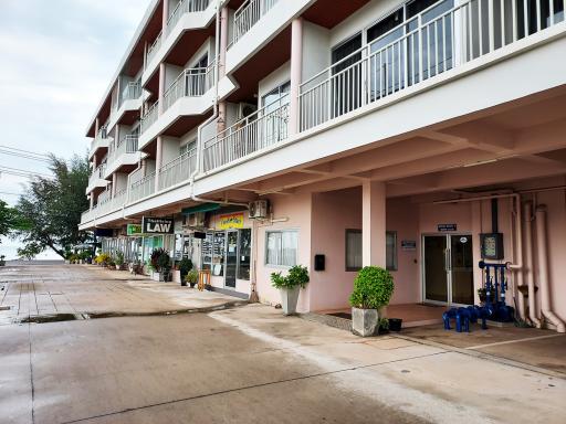 Exterior view of a residential building with commercial shops