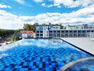 Luxurious rooftop pool with relaxing lounge chairs and a panoramic view of the surrounding buildings