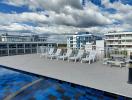Rooftop swimming pool with sun loungers and city view