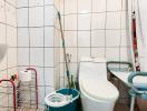 Compact bathroom with white tiling and basic fixtures