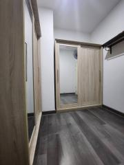 Bright corridor inside a house with wooden doors and laminate flooring