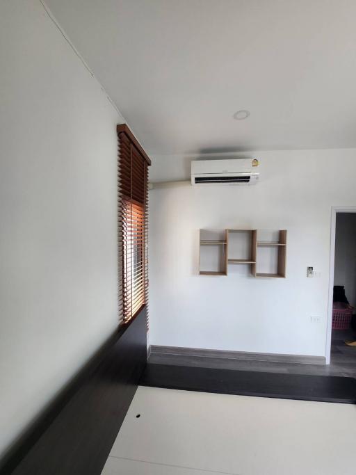 Minimalist bedroom with air conditioning and wooden blinds