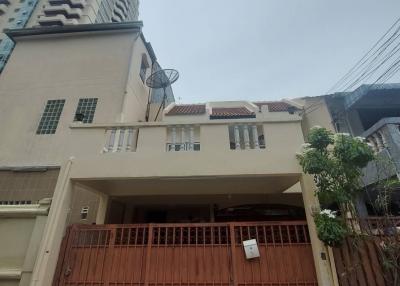 Front view of a multi-story residential building with gated entrance